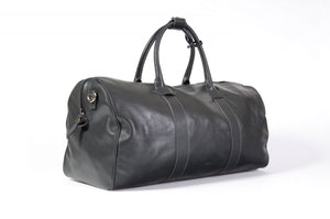 Leather Duffel Bag - This lightweight hand-crafted leather duffel bag is constructed of the finest Italian soft calf leathers. It's perfect for weekend trips that securely fits in the plane overhead. Great for a short trip to the gym or country club as well. The spacious interior also has a secure zippered pocket. Shark Grey.