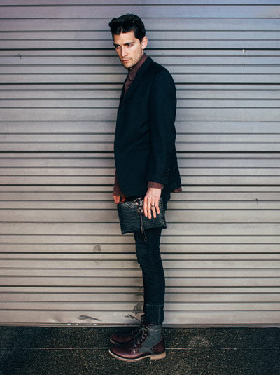 Borlino man holding a handmade leather journal made in Italy.