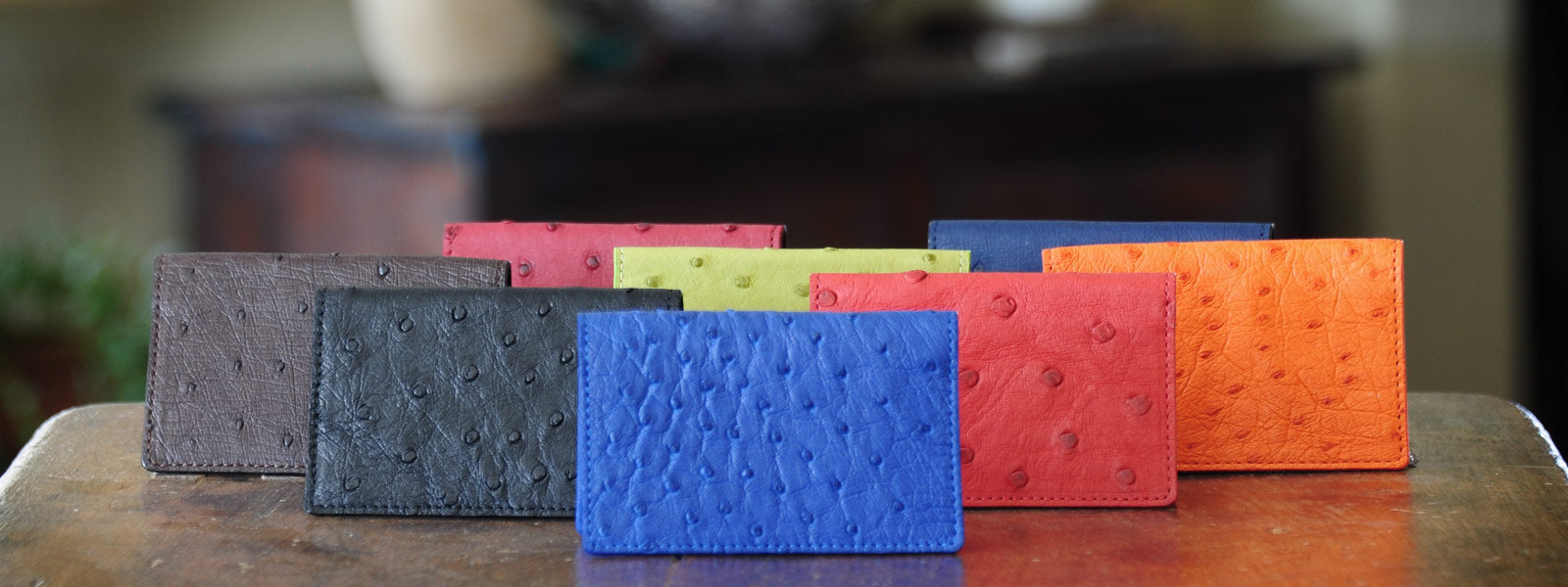 Collection of handmade Italian ostrich leather card cases in vibrant colors, ideal for luxury gifting.