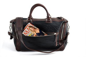 This Leather duffel bag is constructed of the finest Italian Buffalo and Vachetta leathers. It's perfect for weekend trips that securely fits in the plane overhead or under your seat or a short trip to the gym. With 6 pockets inside and out, there's a place for everything. Borlino Onyx and Walnut. 