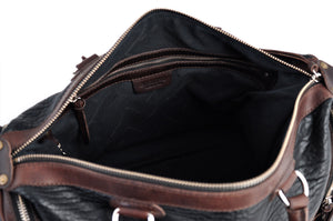 This Leather duffel bag is constructed of the finest Italian Buffalo and Vachetta leathers. It's perfect for weekend trips that securely fits in the plane overhead or under your seat or a short trip to the gym. With 6 pockets inside and out, there's a place for everything. Borlino Onyx and Walnut. 