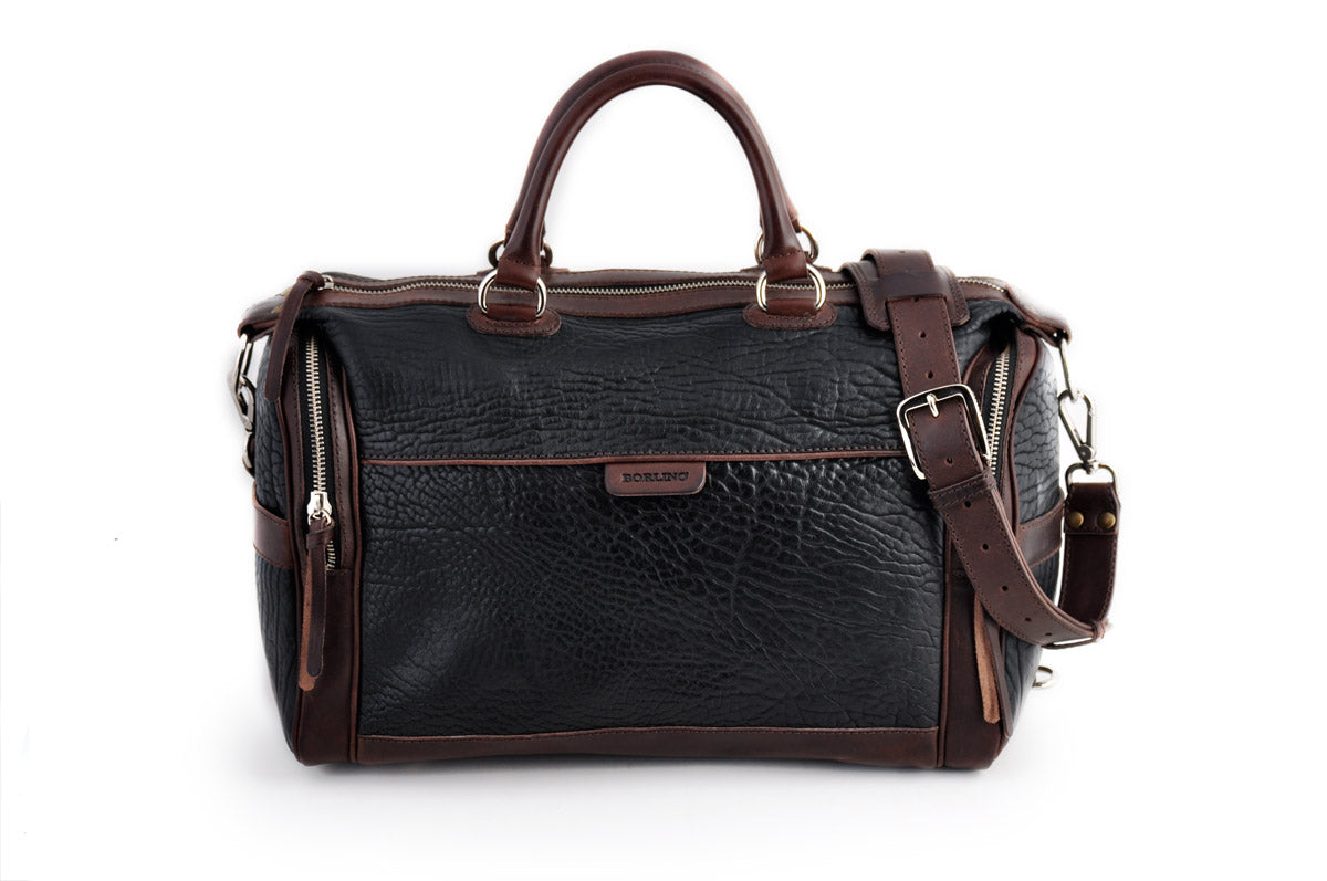 This Leather duffel bag is constructed of the finest Italian Buffalo and Vachetta leathers. It's perfect for weekend trips that securely fits in the plane overhead or under your seat or a short trip to the gym. With 6 pockets inside and out, there's a place for everything. Borlino Onyx and Walnut. 