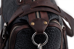 This Leather duffel bag is constructed of the finest Italian Buffalo and Vachetta leathers. It's perfect for weekend trips that securely fits in the plane overhead or under your seat or a short trip to the gym. With 6 pockets inside and out, there's a place for everything. Borlino Onyx and Walnut. 