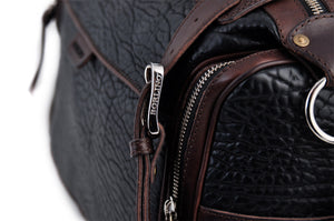 This Leather duffel bag is constructed of the finest Italian Buffalo and Vachetta leathers. It's perfect for weekend trips that securely fits in the plane overhead or under your seat or a short trip to the gym. With 6 pockets inside and out, there's a place for everything. Borlino Onyx and Walnut. 
