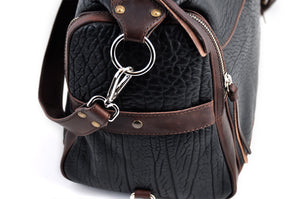 This Leather duffel bag is constructed of the finest Italian Buffalo and Vachetta leathers. It's perfect for weekend trips that securely fits in the plane overhead or under your seat or a short trip to the gym. With 6 pockets inside and out, there's a place for everything. Borlino Onyx and Walnut. 