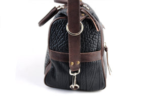 This Leather duffel bag is constructed of the finest Italian Buffalo and Vachetta leathers. It's perfect for weekend trips that securely fits in the plane overhead or under your seat or a short trip to the gym. With 6 pockets inside and out, there's a place for everything. Borlino Onyx and Walnut. 