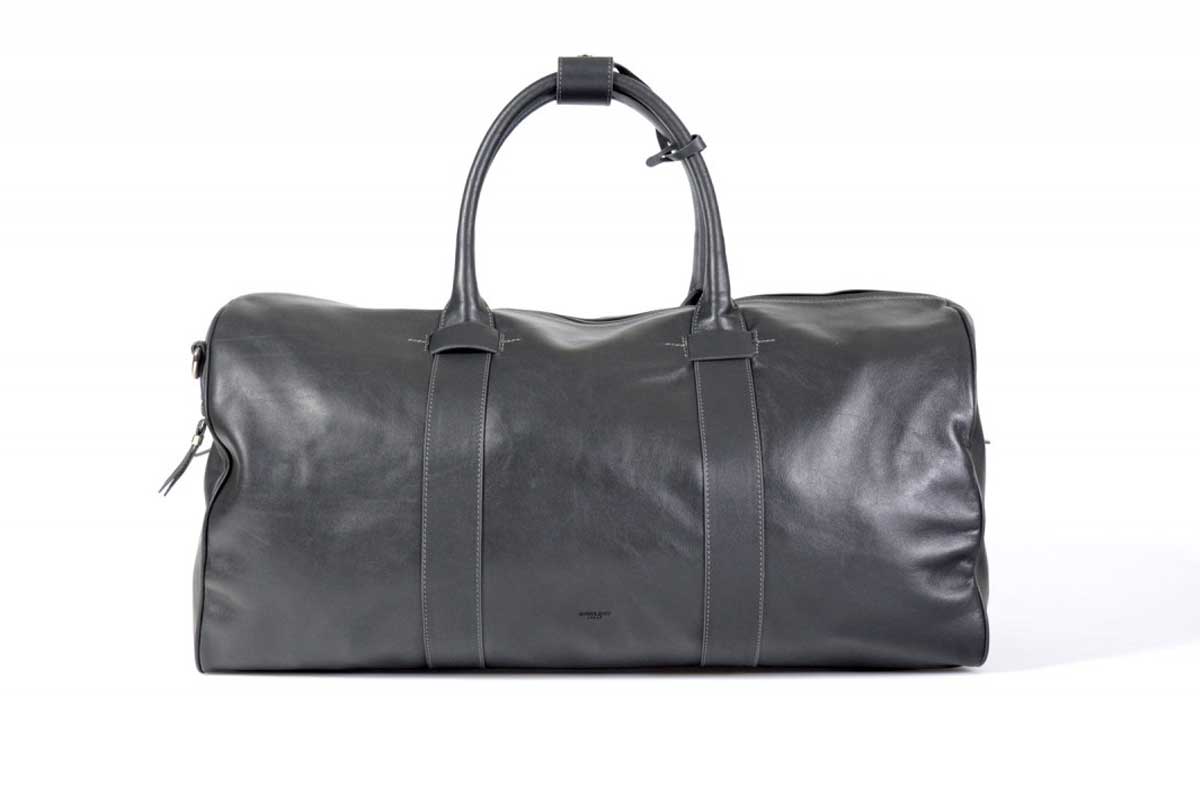 Leather Duffel Bag - This lightweight hand-crafted leather duffel bag is constructed of the finest Italian soft calf leathers. It's perfect for weekend trips that securely fits in the plane overhead. Great for a short trip to the gym or country club as well. The spacious interior also has a secure zippered pocket. Shark Grey.